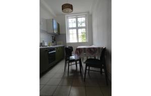 a kitchen with a table and chairs and a window at Stunning Apartment In Waabs With Wifi in Waabs