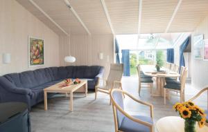 a living room with a blue couch and a table at Strandblick 6 - Dorf 1 in Travemünde