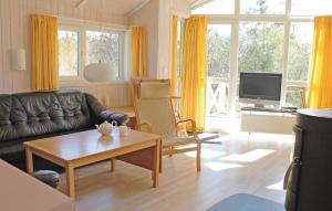 a living room with a couch and a table at Strandblick 8 - Dorf 1 in Travemünde