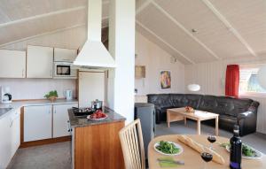 a kitchen and a living room with a table at Strandblick 14 - Dorf 1 in Travemünde
