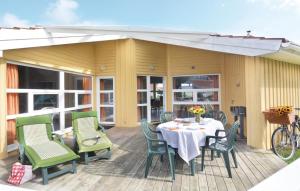 a patio with a table and chairs on a deck at Dünenpark 15 - Dorf 6 in Travemünde +23 photos