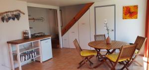 a kitchen and dining room with a table and chairs at Paku Escape - Tairua Bach in Tairua
