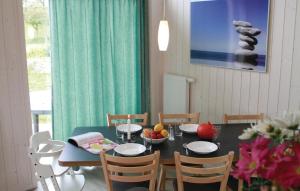 a dining room with a blue table and chairs at Freibeuterweg 9 - Dorf 5 in Travemünde