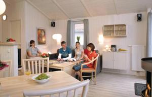 a group of people sitting in a living room at Schatzkiste 11 - Dorf 4 in Travemünde