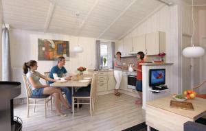 a group of people in a kitchen with a table at Schatzkiste 7 - Dorf 4 in Travemünde