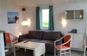 a living room with a couch and a table and chairs at Dnenpark 2 - Dorf 4 in Travemünde