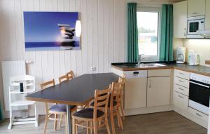 a kitchen with a table and chairs and a sink at Friedrichskoog-Deichblick 8 in Friedrichskoog
