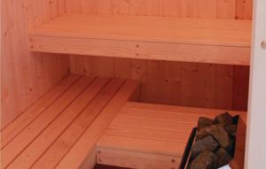 a wooden sauna with a wooden shelf in it at Friedrichskoog-Deichblick 8 in Friedrichskoog