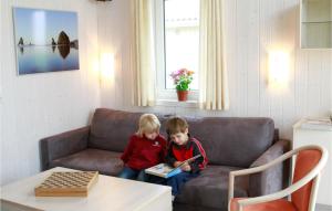 two children sitting on a couch reading a book at Friedrichskoog-Deichblick 9 in Friedrichskoog +14 photos