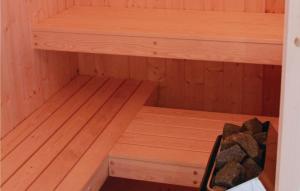 a wooden sauna with wooden shelves and rocks in it at Friedrichskoog-Deichblick 14 in Friedrichskoog