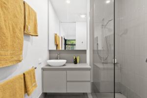 a white bathroom with a sink and a shower at Wye9 in Wye River