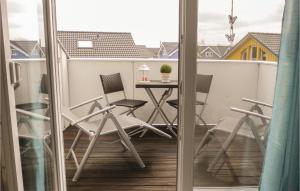 a balcony with a table and chairs on a balcony at Haus Seeadler 5 in Süssau