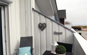 a porch with two chairs and a heart on the wall at Haus Seeadler 5 in Süssau