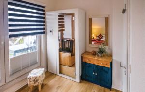 ein Zimmer mit einem Spiegel und ein Schlafzimmer mit einem Bett in der Unterkunft Haus Seeadler 2 in Süssau