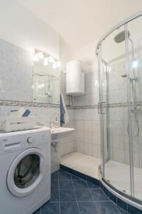a bathroom with a washing machine and a shower at Apartment Diocletian in Split