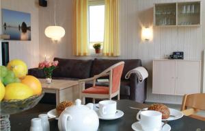a living room with a table with plates and cups at Friedrichskoog-Deichblick 3 in Friedrichskoog