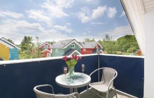 a table with a vase of flowers on a balcony at Haus Seeadler 1 in Süssau