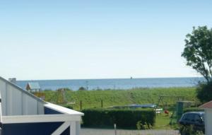a view of a playground with the ocean in the background at Haus Seeadler 1 in Süssau
