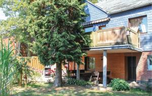 a house with a tree and a balcony at Gorgeous Home In Gleima With Kitchen in Gleima