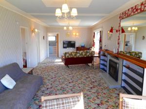 a living room with a couch and a television at Bobs Bach - Mt Maunganui Bach in Mount Maunganui
