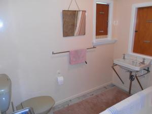a bathroom with a sink and a toilet at Bobs Bach - Mt Maunganui Bach in Mount Maunganui +16 photos