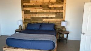 1 dormitorio con 1 cama con cabecero de madera en HACIENDA 7 AMORES en El Porvenir