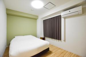 Postel nebo postele na pokoji v ubytování Randor Residence Tokyo Suites