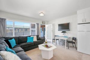 a living room with a couch and a table at Central Stay - Taupo Flat in Taupo