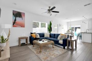 a living room with a blue couch and a table at Few steps to Ocean-4 Beach Cruisers & Free parking & Private backyard in Jacksonville Beach