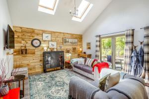 a living room with a couch and a fireplace at Grant Cottage in Acharacle