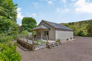 a small house with a garden in front of it at Grant Cottage in Acharacle