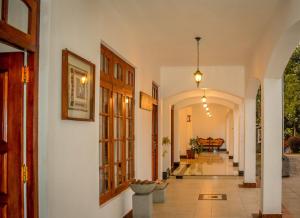 a hallway of a house with a piano in the distance at Elegant Hotel, Kandy in Kandy