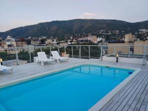 a swimming pool on a deck with a view of a city at Apartamento Carlos Paz in Villa Carlos Paz