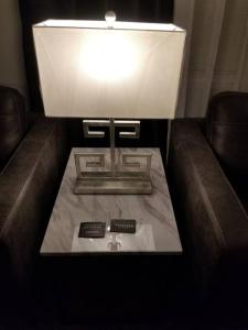a lamp with two remote controls on a couch at *NEW*ENTIRE HOME IN ROSE DISTRICT*DINE*SHOP*FUN in Broken Arrow