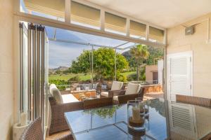 a living room with a glass table with a view at Mallorca Holiday House for Rent Del mar 37 in Colonia de Sant Pere