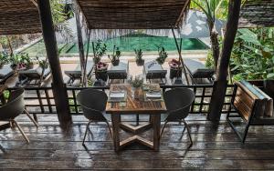 a dining room with a table and chairs at La Bastide de Caro in Siem Reap