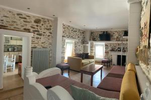 a living room with a couch and a table at Sea&Stone Apartment in Skala Sotiros