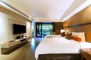 Rúm í herbergi á Grand View Resort Beitou