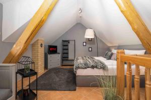 1 dormitorio con 1 cama en el ático en Select-Home 1 - Wellnesshaus Sandmühle - mit privater Sauna, en Bruck in der Oberpfalz