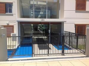a building with a gate in front of it at Taupo Vista - Taupo Apartment in Taupo