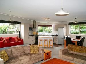 a living room with a couch and a kitchen at 45 Below - National Park Holiday Home in National Park