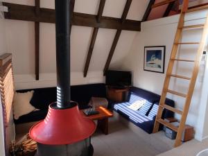 a living room with a wood stove in a room at Adventure A-Frame - Ohakune Holiday Home in Ohakune