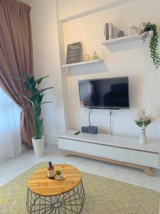 a living room with a tv and a coffee table at #Netflix #Cuckoo Troika Kota Bharu Homestay 0182 in Kota Bharu