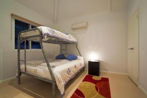 a bedroom with a bunk bed and a rug at Osprey Holiday Village Unit 103 2 Bedroom in Exmouth