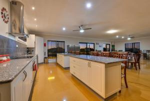 a kitchen with a counter top and a dining room at 16 Crevalle Way in Exmouth