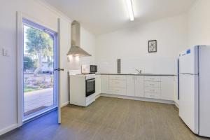 a kitchen with white appliances and a refrigerator at Getaway Villas Unit 3811 in Exmouth