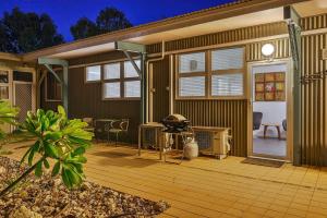 a house with a deck with a grill on it at Getaway Villas Unit 3811 in Exmouth