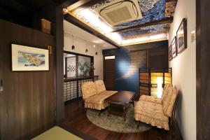 a living room with two chairs and a table at Hidatakayama Ukiyoe INN Garon - Vacation STAY 12320v in Takayama