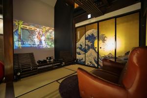 a waiting room with a chair and a large screen at Hidatakayama Ukiyoe INN Garon - Vacation STAY 12320v in Takayama