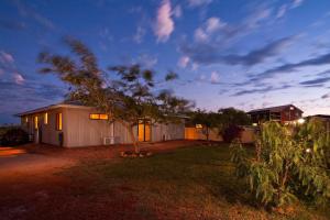 a house with a tree in a yard at night at 9 Skipjack Circle in Exmouth